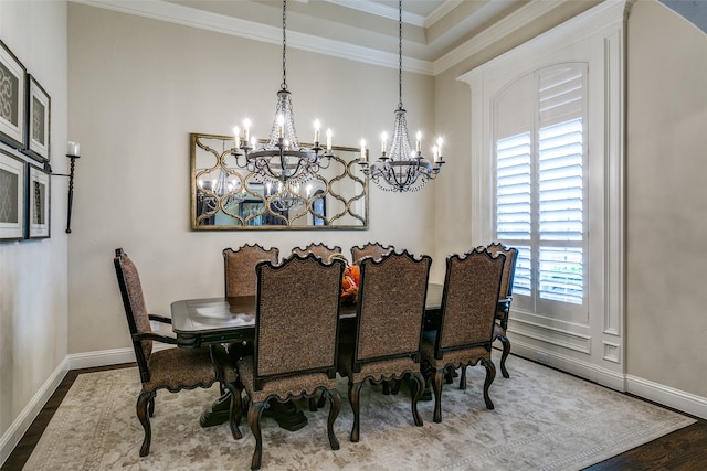 dining area featuring hardwood / wood-style flooring, a chandelier, and ornamental molding