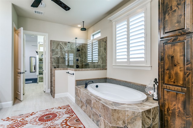 bathroom with separate shower and tub, hardwood / wood-style flooring, and ceiling fan