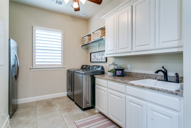 washroom with cabinets, washer and clothes dryer, light tile patterned floors, sink, and ceiling fan