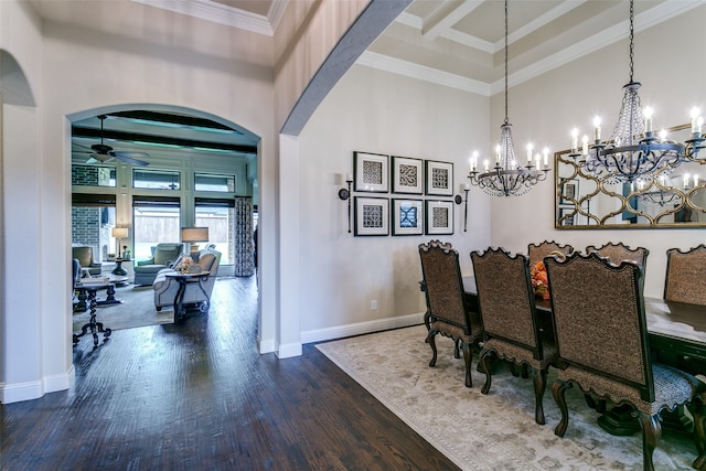 dining area with crown molding, a towering ceiling, ceiling fan with notable chandelier, and dark hardwood / wood-style flooring