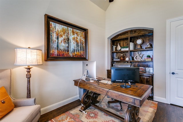 office space featuring dark hardwood / wood-style floors and vaulted ceiling