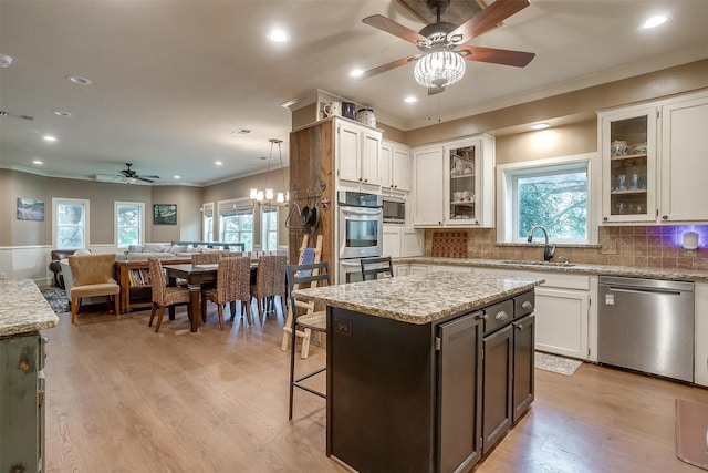 kitchen with white cabinetry, sink, a kitchen island, and stainless steel appliances