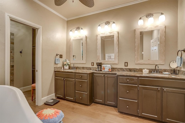 1645 County Road 1105, Rio Vista, TX 76093 - full bath with wood finished floors, double vanity, a sink, and ornamental molding
