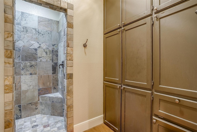 bathroom with tiled shower