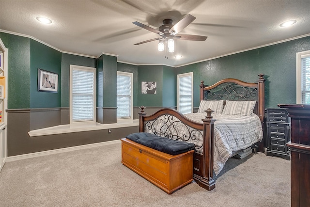 carpeted bedroom with ceiling fan, crown molding, and multiple windows