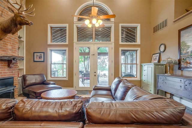 1645 County Road 1105, Rio Vista, TX 76093 - living area with french doors, visible vents, ceiling fan, and a high ceiling