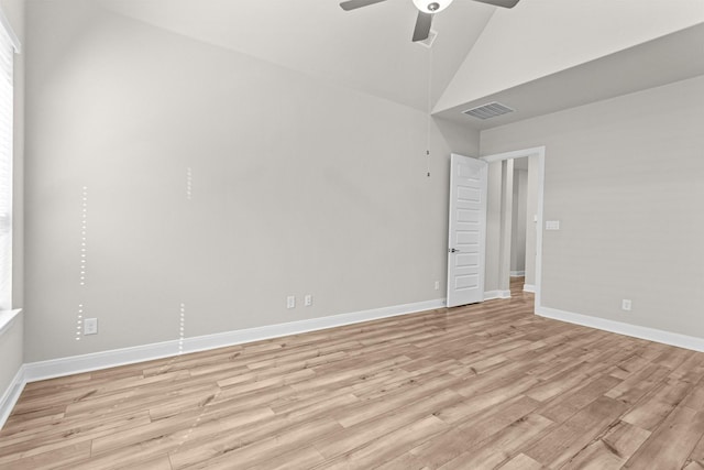 spare room featuring lofted ceiling, ceiling fan, and light wood-type flooring