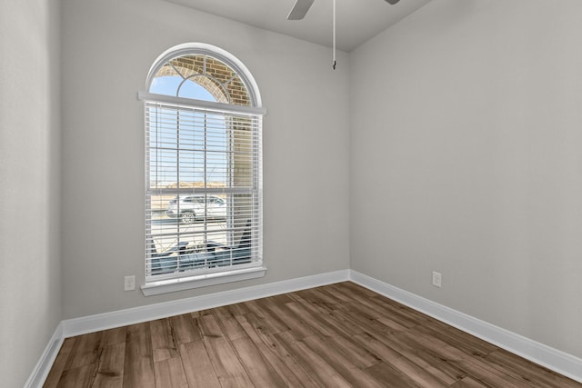 spare room featuring wood-type flooring and ceiling fan