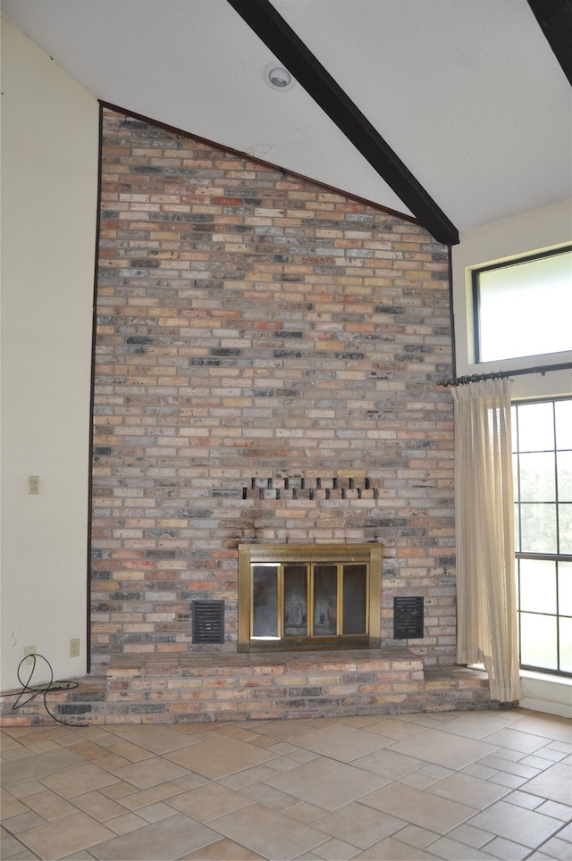 interior space featuring a brick fireplace and beam ceiling