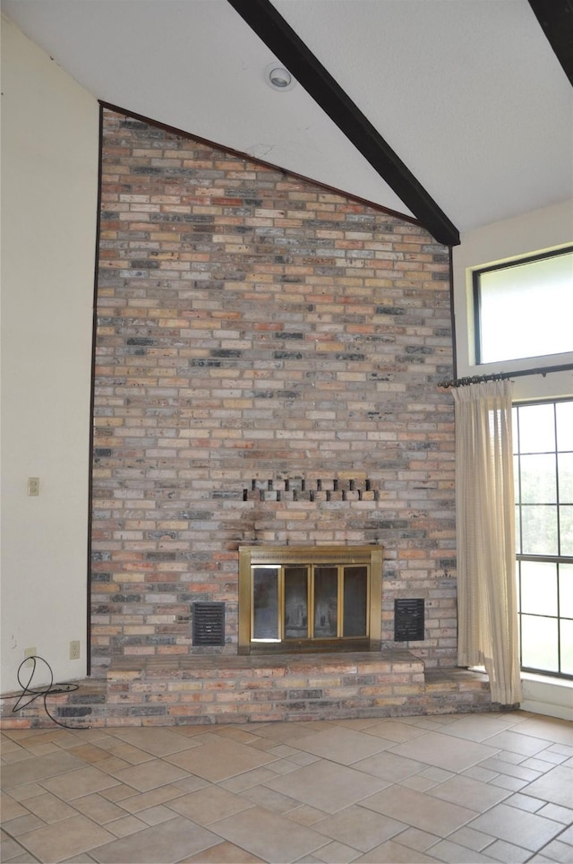 unfurnished living room featuring beamed ceiling, a fireplace, tile patterned flooring, and visible vents