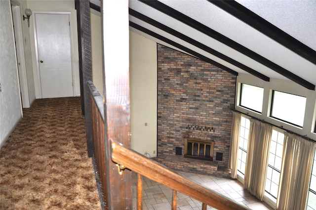 hallway with high vaulted ceiling and carpet floors