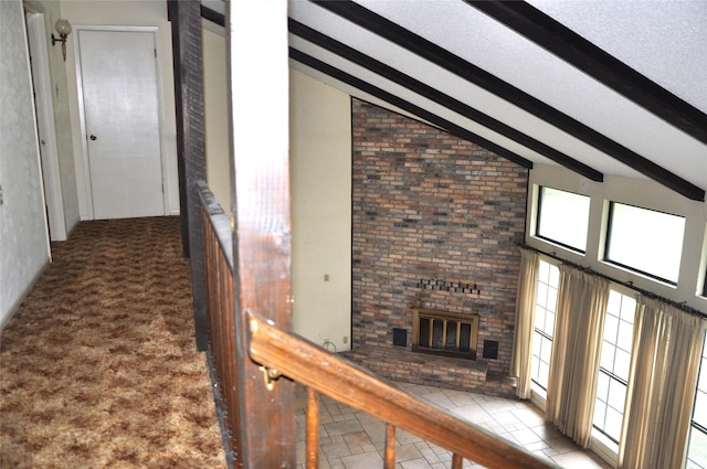 hallway featuring a textured ceiling, carpet floors, beamed ceiling, and high vaulted ceiling