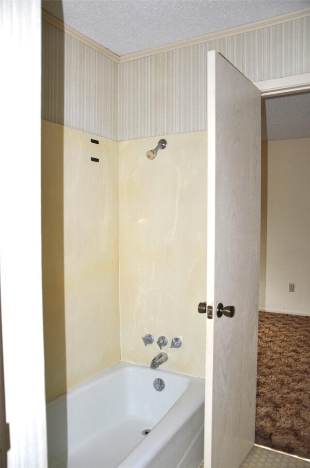 bathroom featuring a textured ceiling and bathtub / shower combination