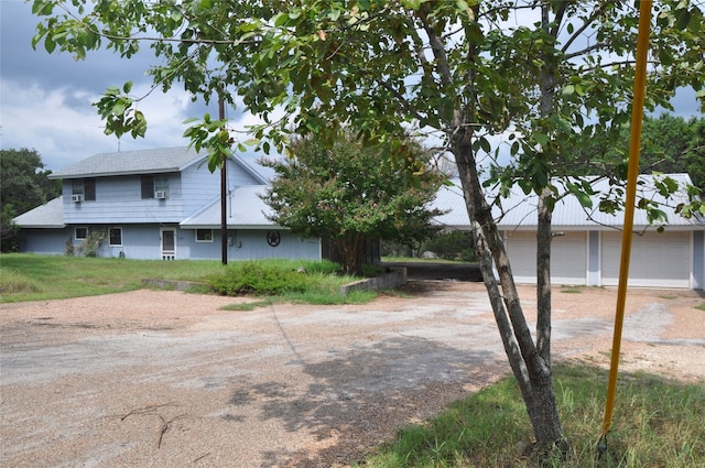 view of side of home featuring a garage and driveway