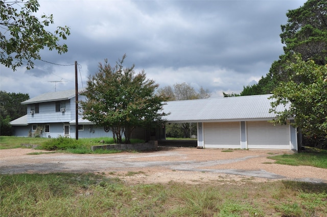 view of front facade featuring an outbuilding and driveway
