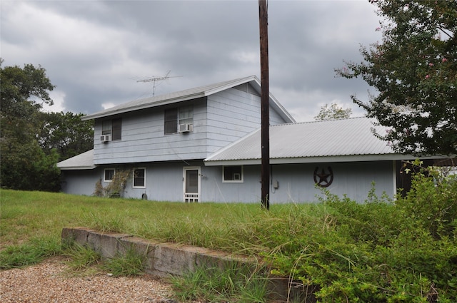 rear view of house featuring cooling unit