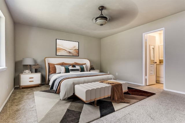 bedroom with light carpet, connected bathroom, and ceiling fan