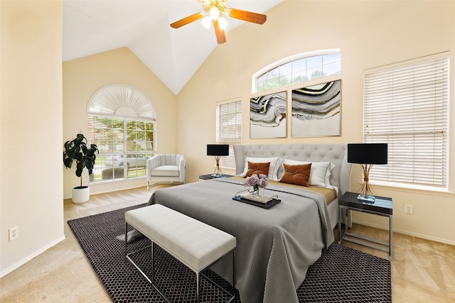 bedroom with lofted ceiling, ceiling fan, and light carpet