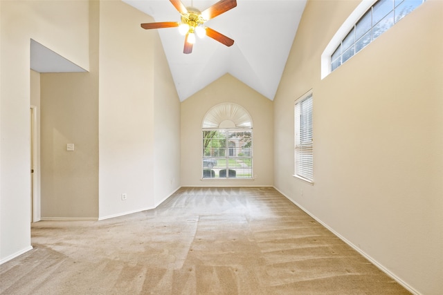 carpeted spare room with high vaulted ceiling and ceiling fan