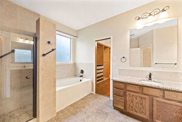 bathroom featuring tile patterned flooring, separate shower and tub, and vanity