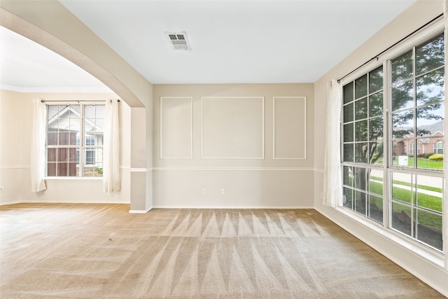 interior space featuring a wealth of natural light and crown molding