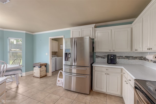 kitchen featuring washer and dryer, stainless steel appliances, and white cabinetry