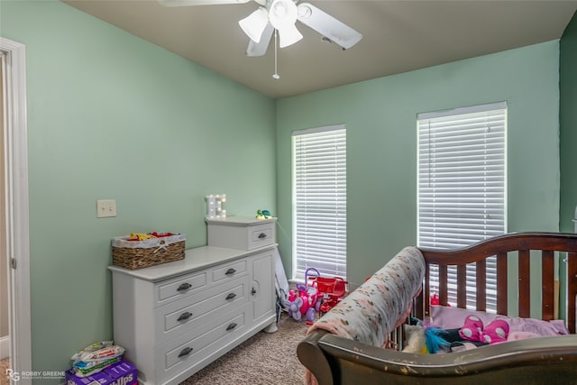 carpeted bedroom with ceiling fan and multiple windows