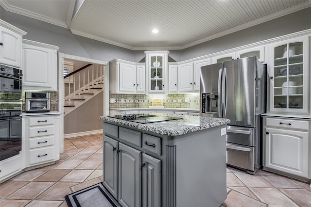 kitchen featuring ornamental molding, white cabinetry, black appliances, a kitchen island, and gray cabinetry