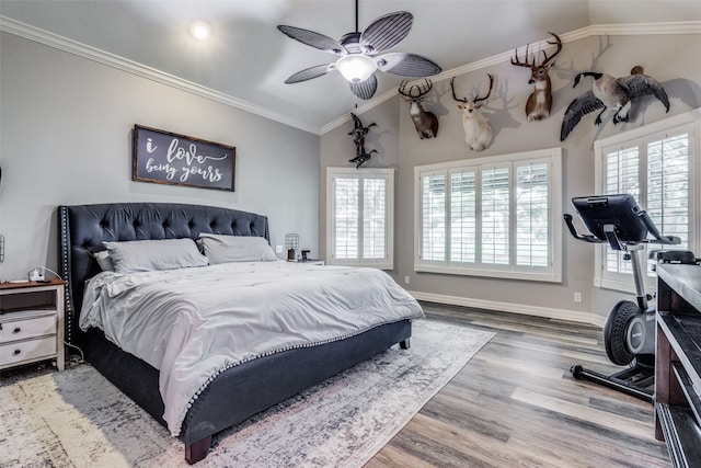 bedroom featuring wood-type flooring, vaulted ceiling, ceiling fan, and multiple windows