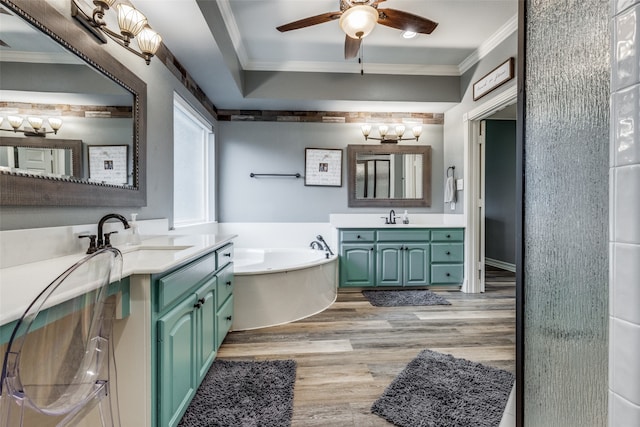 bathroom featuring vanity, a bath, wood-type flooring, crown molding, and ceiling fan