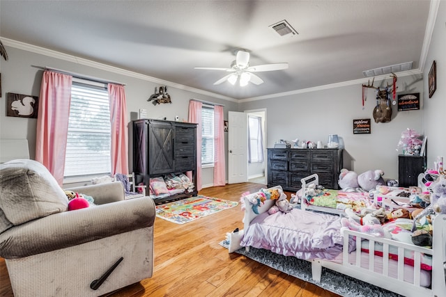 bedroom with hardwood / wood-style floors, ceiling fan, and ornamental molding