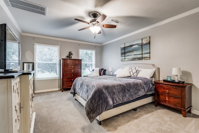 carpeted bedroom with ceiling fan and ornamental molding