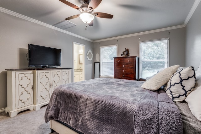 carpeted bedroom featuring ensuite bath, ornamental molding, and ceiling fan