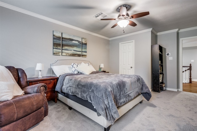 carpeted bedroom featuring ornamental molding and ceiling fan