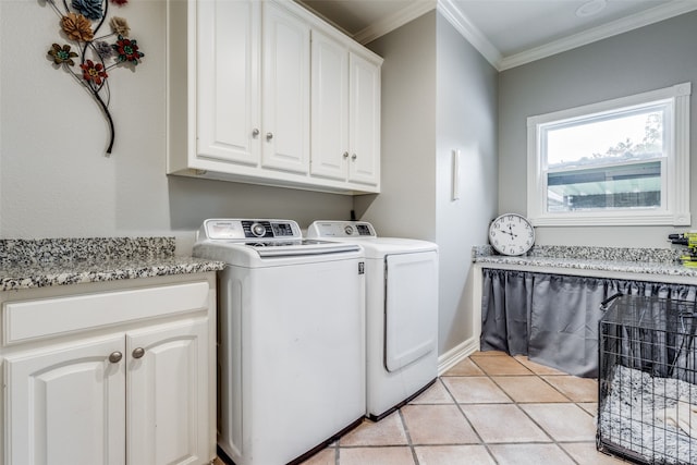 laundry room with cabinets, washer and clothes dryer, ornamental molding, and light tile patterned floors