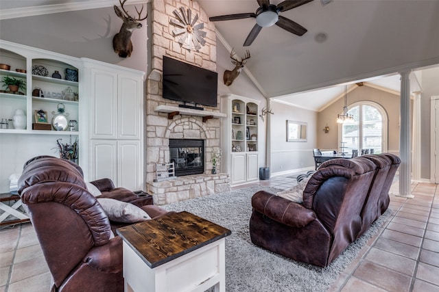 living room with a fireplace, lofted ceiling, ornamental molding, and ceiling fan with notable chandelier