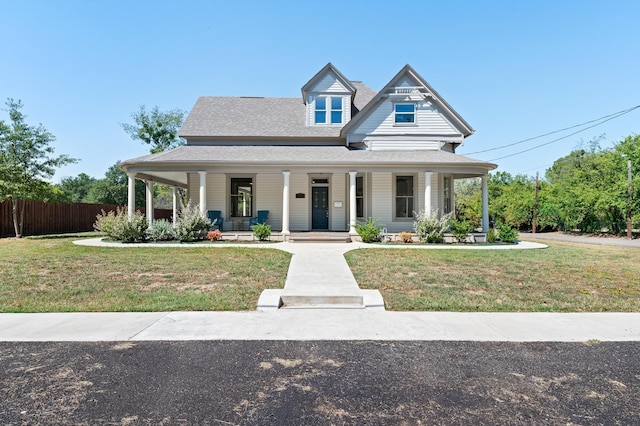 farmhouse with a front lawn and a porch