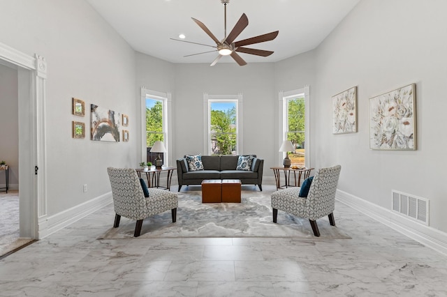 living area featuring ceiling fan and plenty of natural light