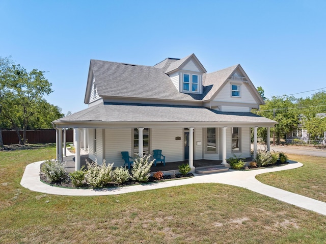 view of front facade with a front yard and covered porch