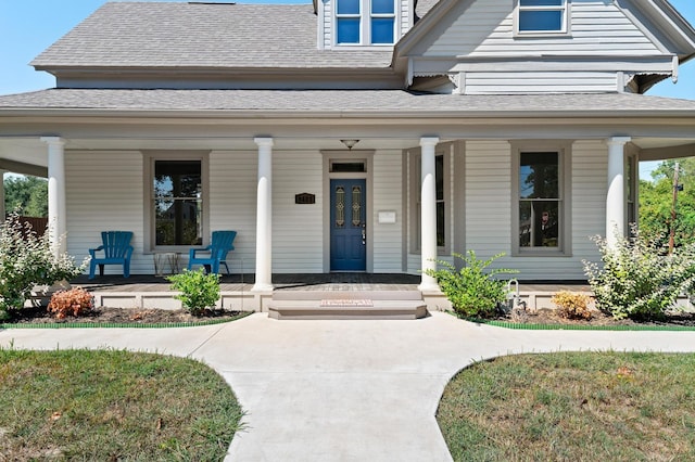 1401 Arp St, Commerce, TX 75428 - view of exterior entry with a porch and roof with shingles