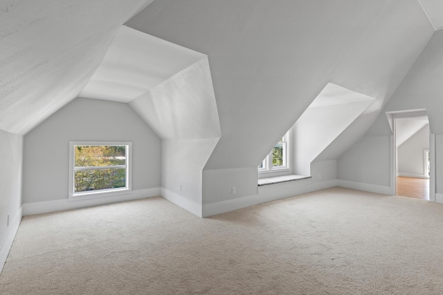 1401 Arp St, Commerce, TX 75428 - bonus room with healthy amount of natural light, vaulted ceiling, carpet flooring, and baseboards