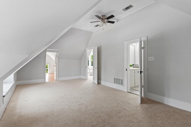 bonus room featuring ceiling fan, carpet floors, and vaulted ceiling