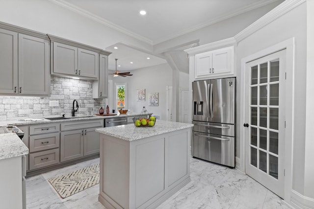 1401 Arp St, Commerce, TX 75428 - kitchen featuring appliances with stainless steel finishes, a sink, gray cabinets, light marble finish floors, and ornamental molding
