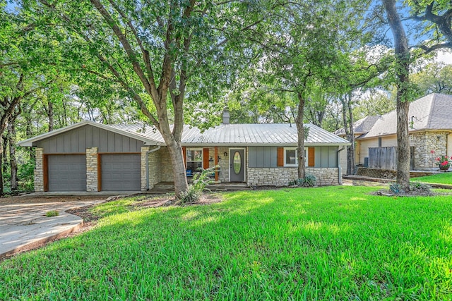 ranch-style home with a garage and a front lawn