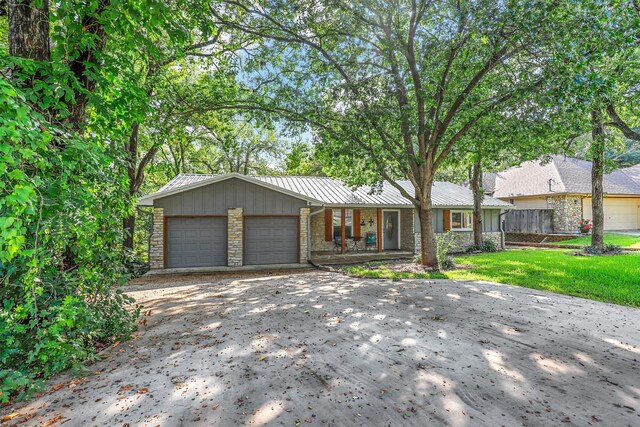 ranch-style house with a front yard and a garage