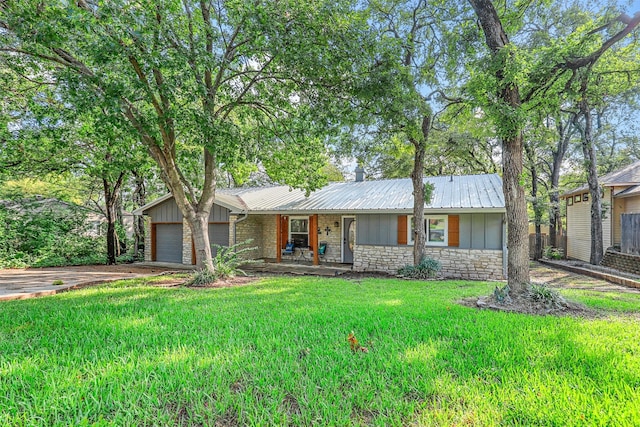 ranch-style house featuring a front yard and a garage