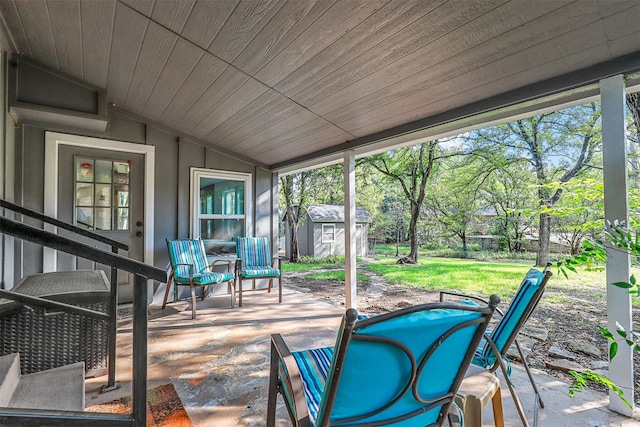 exterior space with a healthy amount of sunlight, vaulted ceiling, and wooden ceiling