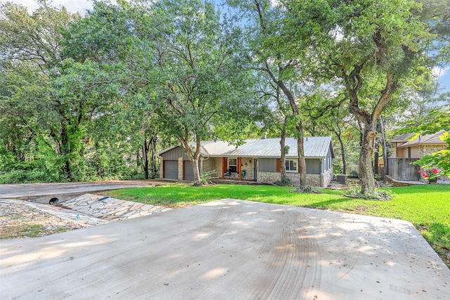 view of front of house with a garage and a front yard