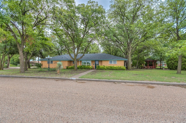 ranch-style house featuring a gazebo and a front yard