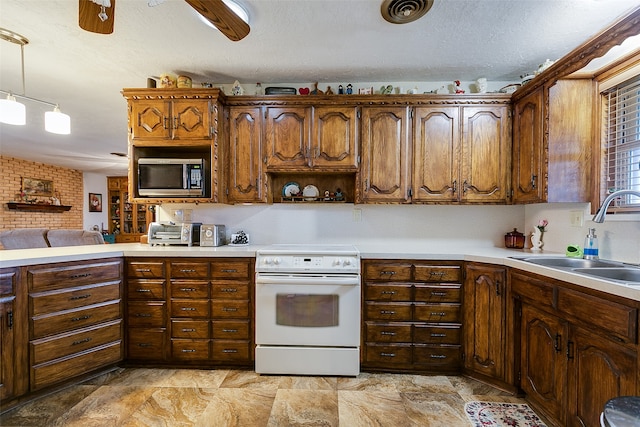 kitchen featuring decorative light fixtures, electric range, sink, ceiling fan, and stainless steel microwave